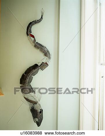 Close-up of metal snake on wall View Large Photo Image Stock Photo - Close-up of metal snake on wall. Fotosearch