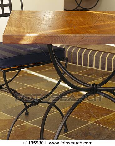 Close-up of metal table and chair on limestone floor tiles View Large Photo Image Stock Image - Close-up of metal table and chair on limestone floor tiles. Fotosearch