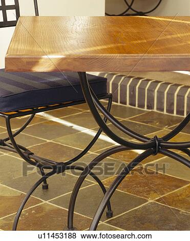 Close-up of metal table and chair on limestone floor tiles View Large Photo Image Stock Photo - Close-up of metal table and chair on limestone floor tiles. Fotosearch