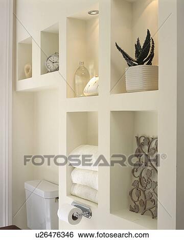 Stock Photograph - Close up of modern alcove shelving in white bathroom. Fotosearch