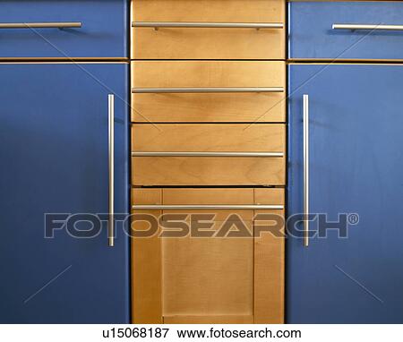 Stock Photo - Close-up of modern blue fitted kitchen cupboard with steel handles. Fotosearch