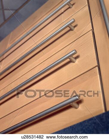 Close Up Of Modern Fitted Kitchen Cupboard With Long Stainless