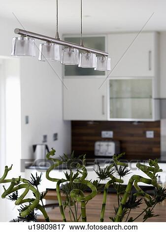Stock Photo - Close-up of modern glass and chrome lighting in modern kitchen. Fotosearch