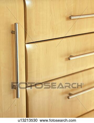 Stock Image - Close-up of modern kitchen drawers. Fotosearch