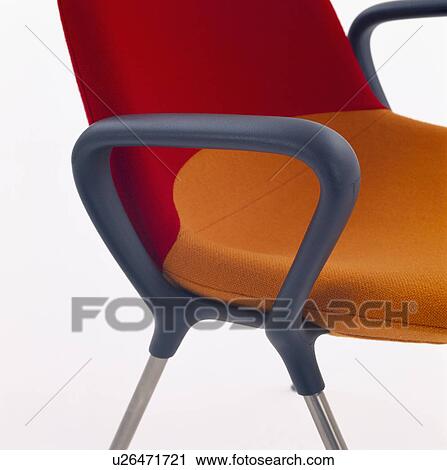 Stock Image - Close-up of modern office chair with red and orange seat. Fotosearch