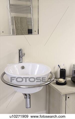 Close-up of modern white circular basin in chrome frame View Large Photo Image Stock Photo - Close-up of modern white circular basin in chrome frame. Fotosearch