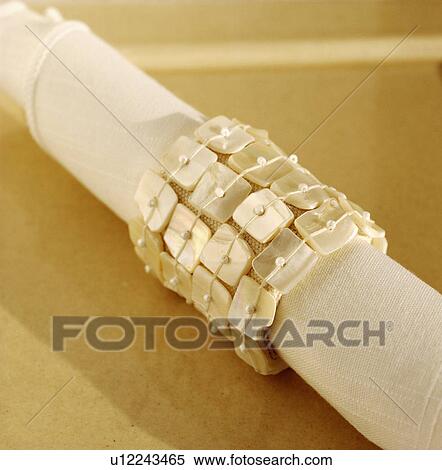 Close-up of mother-of-pearl napkin-ring on linen table-napkin View Large Photo Image Stock Photography - Close-up of mother-of-pearl napkin-ring on linen table-napkin. Fotosearch