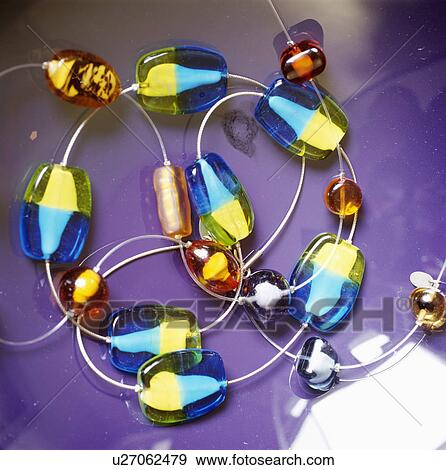 Close-up of multi-coloured glass bead necklace View Large Photo Image Stock Photo - Close-up of multi-coloured glass bead necklace. Fotosearch