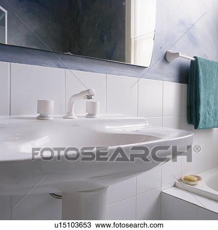 Stock Image - Close-up of of white pedestal basin. Fotosearch