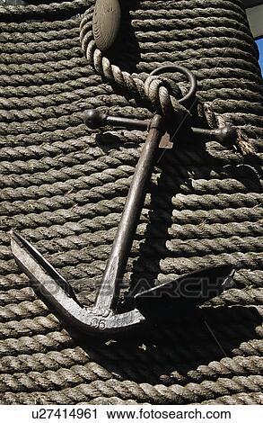 Stock Image - Close up of old iron anchor on rope&#10;. Fotosearch