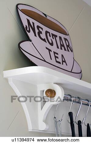 Close-up of old Nectar Tea advertising sign on white kitchen shelf with utensils on hooks View Large Photo Image Picture - Close-up of old Nectar Tea advertising sign on white kitchen shelf with utensils on hooks. Fotosearch