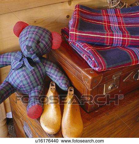 Close-up of old wooden shoe trees with tartan teddy bear and leather suitcase View Large Photo Image Stock Image - Close-up of old wooden shoe trees with tartan teddy bear and leather suitcase. Fotosearch