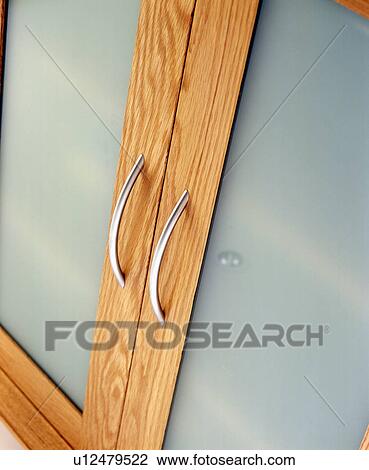 Stock Image - Close-up of opaque glass kitchen cupboard doors. Fotosearch