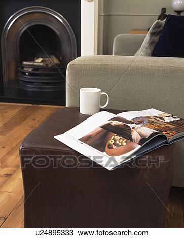 Close-up of open book and coffee cup on brown leather cube stool View Large Photo Image Stock Image - Close-up of open book and coffee cup on brown leather cube stool. Fotosearch