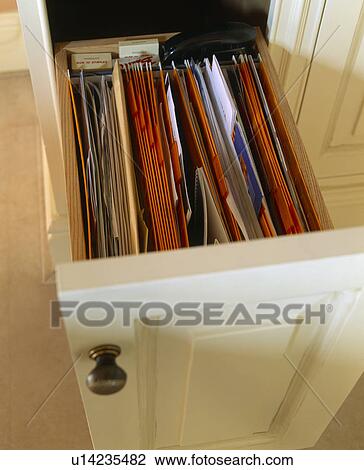 Stock Image - Close-up of open drawer storing files. Fotosearch