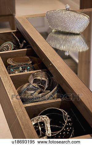 Stock Photography - Close-up of open drawer storing jewellery in modern dressing table. Fotosearch