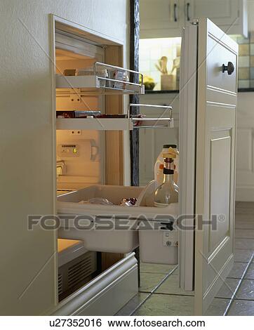 Stock Photograph - Close-up of open refrigerator with shelves attached to pull-out door. Fotosearch
