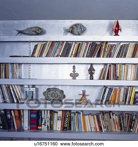 Close-up of ornaments and books on shelves View Large Photo Image Stock Image - Close-up of ornaments and books on shelves. Fotosearch