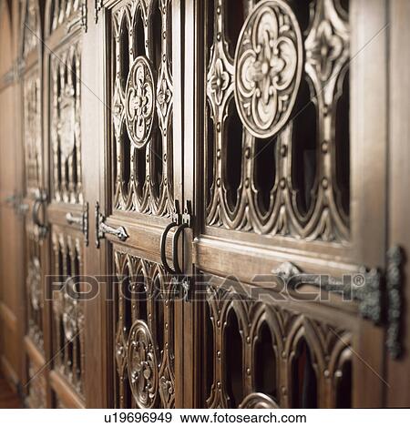 Stock Photo - Close up of ornately carved Medieval wooden doors. Fotosearch