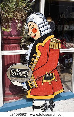 Stock Image - Close-up of painted figure advertising antique shop. Fotosearch