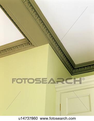 Stock Image - Close-up of painted green cornice. Fotosearch