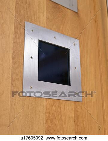 Stock Image - Close-up of panelled wall with metal switch. Fotosearch