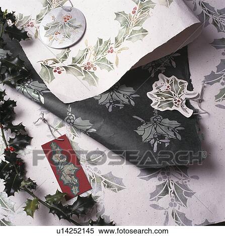 Close-up of paper with stencilled holly View Large Photo Image Stock Photography - Close-up of paper with stencilled holly. Fotosearch