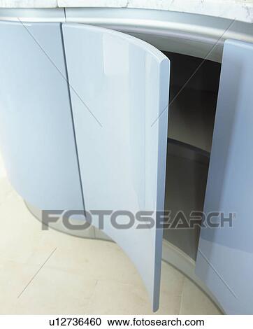 Close-up of pastel blue curved kitchen unit with door open View Large Photo Image Stock Image - Close-up of pastel blue curved kitchen unit with door open. Fotosearch