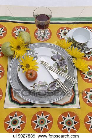 Stock Photography - Close-up of patterned yellow cloth and grey crockery. Fotosearch