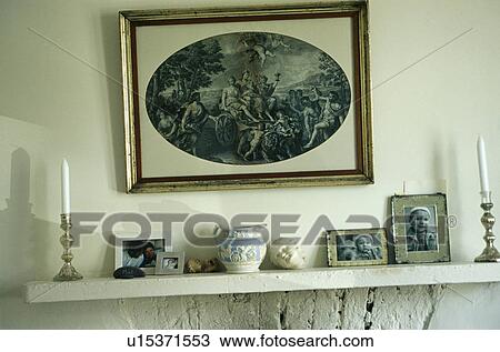 Close-up of picture above photographs and jug on stone mantelpiece View Large Photo Image Stock Image - Close-up of picture above photographs and jug on stone mantelpiece. Fotosearch