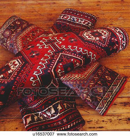 Close-up of pile of red patterned oriental carpets View Large Photo Image Stock Photo - Close-up of pile of red patterned oriental carpets. Fotosearch