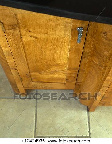 Stock Photography - Close-up of pippy-oak fitted kitchen unit. Fotosearch