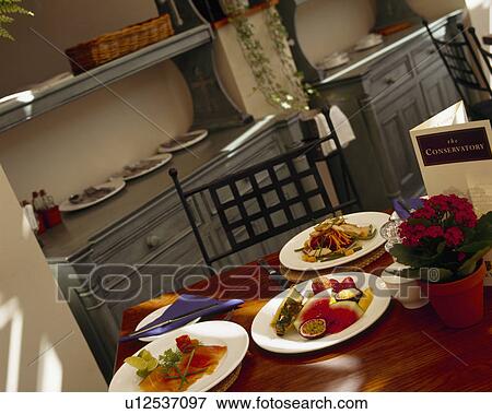 Stock Photo - Close-up of plates of food on table. Fotosearch