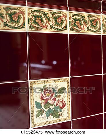 Stock Photography - Close-up of purple wall-tiles with floral inserts. Fotosearch
