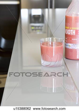 Close-up of raspberry+banana smoothie in glass on kitchen worktop View Large Photo Image Stock Image - Close-up of raspberry+banana smoothie in glass on kitchen worktop. Fotosearch