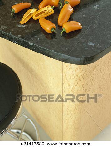 Close-up of red peppers on granite worktop View Large Photo Image Stock Image - Close-up of red peppers on granite worktop. Fotosearch