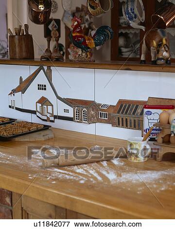 Close-up of rolling pin on floury wooden worktop below pictorial wall tiles View Large Photo Image Stock Photo - Close-up of rolling pin on floury wooden worktop below pictorial wall tiles. Fotosearch