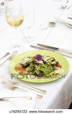 Close-up of salad greens with shaved Parmesan on green plate with silvery cutlery View Large Photo Image Stock Image - Close-up of salad greens with shaved Parmesan on green plate with silvery cutlery. Fotosearch