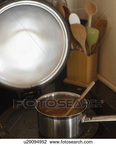 Stock Image - Close-up of saucepan on hob. Fotosearch