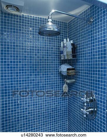 Close-up of shower-head in blue tiled shower in modern blue bathroom View Large Photo Image Stock Image - Close-up of shower-head in blue tiled shower in modern blue bathroom. Fotosearch