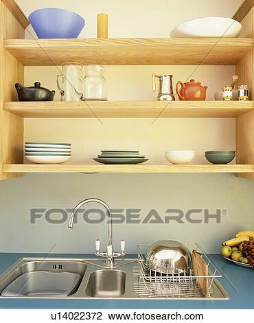 Close-up of simple wooden shelves above stainless steel sink View Large Photo Image Stock Image - Close-up of simple wooden shelves above stainless steel sink. Fotosearch