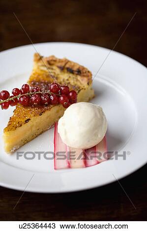 Stock Image - Close-up of slice of lemon torte with icecream. Fotosearch
