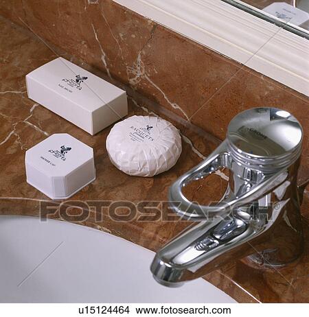 Close-up of soaps on bathroom basin with chrome tap View Large Photo Image Picture - Close-up of soaps on bathroom basin with chrome tap. Fotosearch