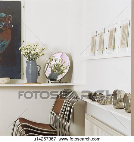 Close-up of stacking chairs in studio apartment View Large Photo Image Stock Photo - Close-up of stacking chairs in studio apartment. Fotosearch