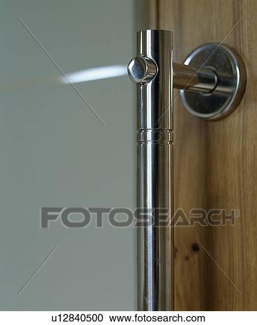 Stock Image - Close-up of stainless steel door handle. Fotosearch