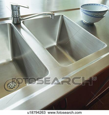 Stock Image - Close-up of stainless steel double sink and tap. Fotosearch