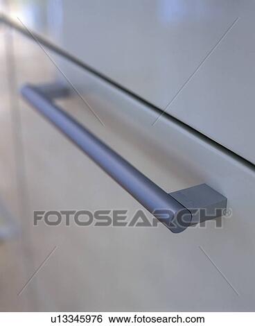 Close-up of stainless steel handle on cupboard door View Large Photo Image Stock Photograph - Close-up of stainless steel handle on cupboard door. Fotosearch