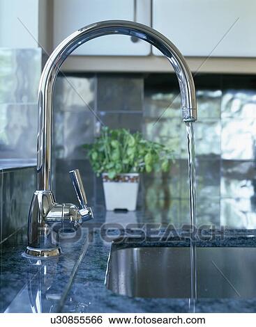 Close-up of stainless steel mixer-tap pouring water into underset sink View Large Photo Image Stock Photograph - Close-up of stainless steel mixer-tap pouring water into underset sink. Fotosearch