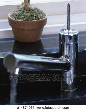 Stock Photography - Close-up of stainless steel mixer tap. Fotosearch