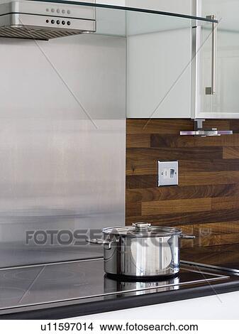 Close-up of stainless steel pan on halogen hob View Large Photo Image Picture - Close-up of stainless steel pan on halogen hob. Fotosearch